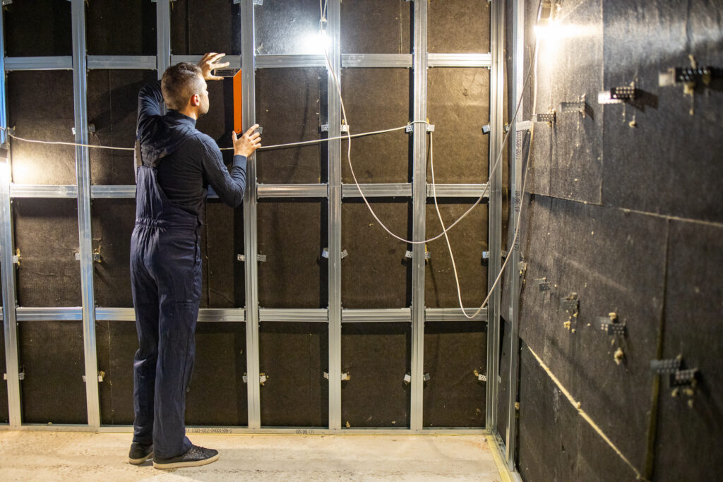 Picture of a tradesperson soundproofing a home