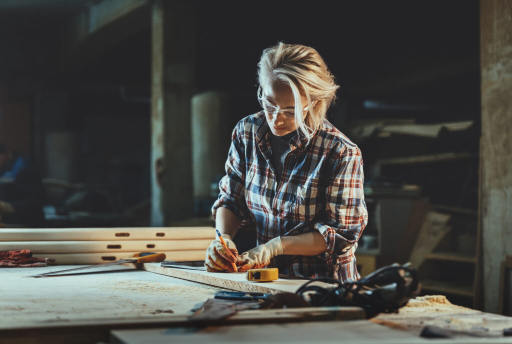 Picture of a tradesperson carpenter working with a ruler and wood