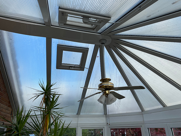 Picture of a glass conservatory with a fan