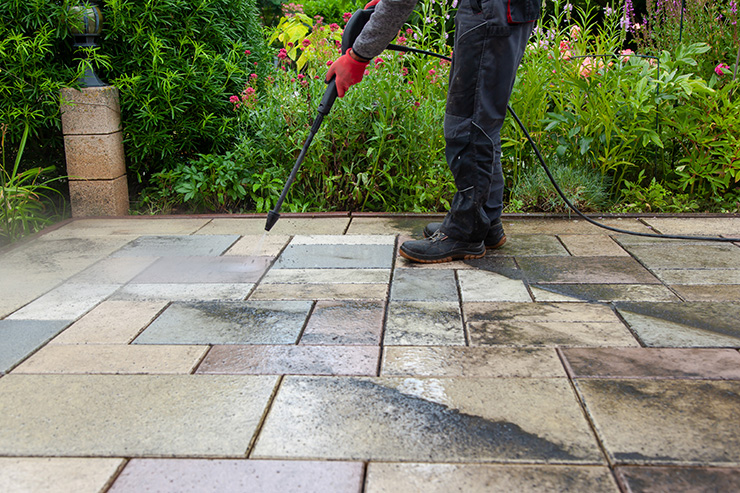 Picture of a person cleaning a patio