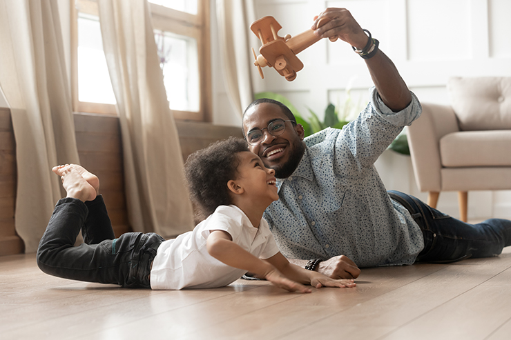 Picture of a father and child playing on a newly renovated underfloor heating floor