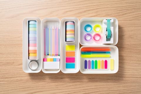 organized and sorted adhesive tape and bookmark in white trays