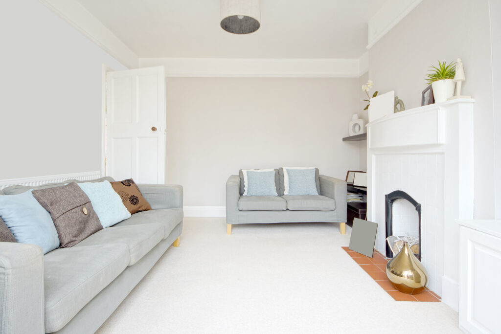 Picture of a living room with white walls and floor and chimney