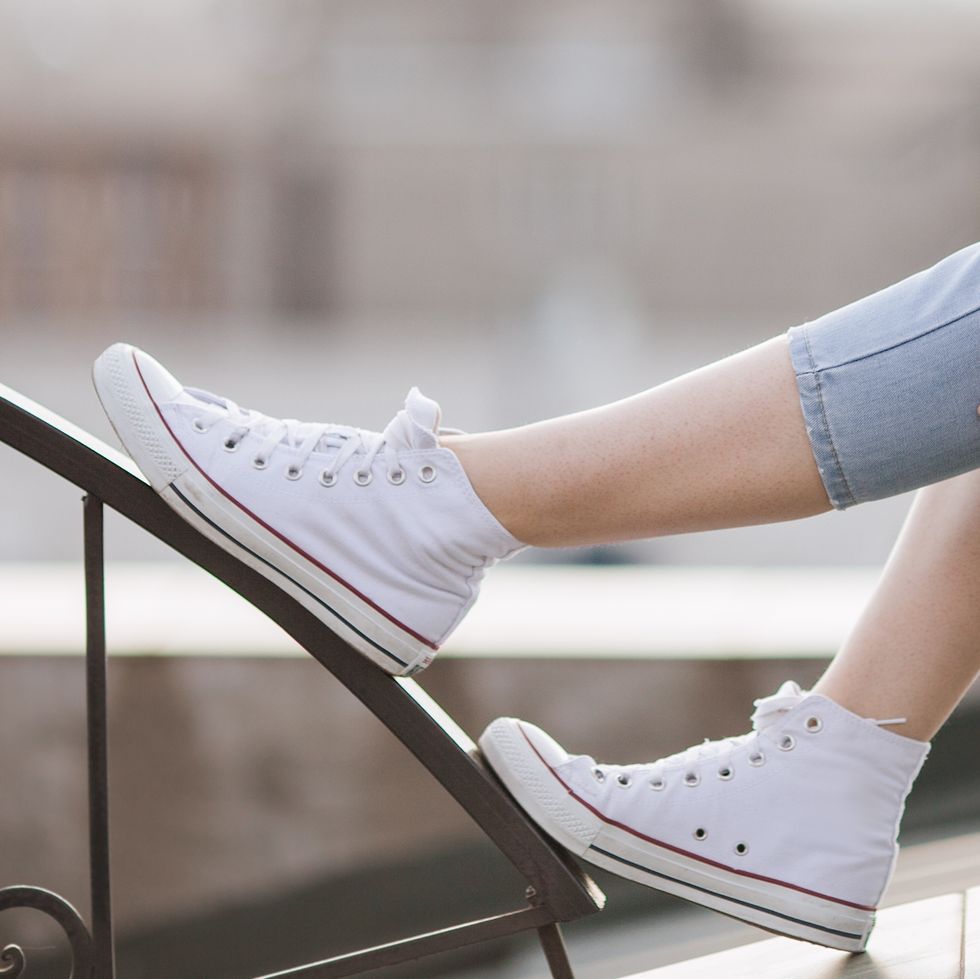 how to clean white shoes, close up of a person wearing white shoes