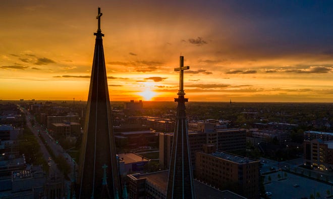 The Gesu church steeple is seen as the sun sets at Marquette University on Sunday May 15, 2022.