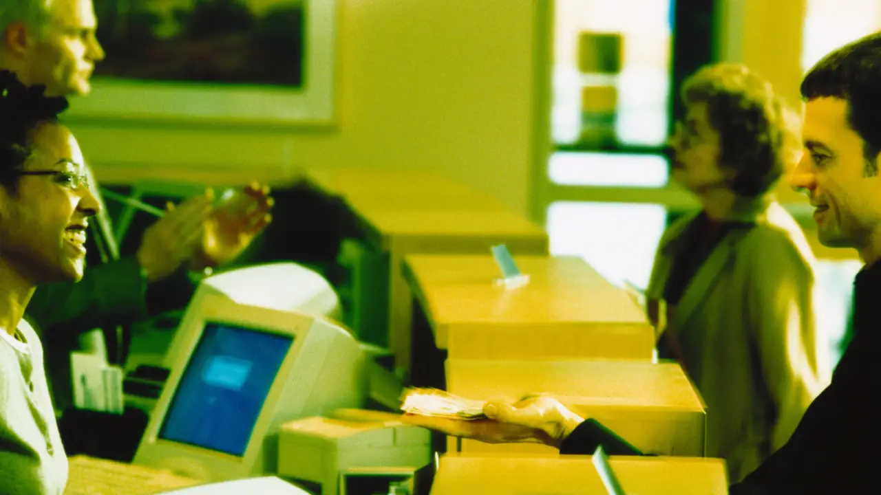 Short term loans - man talking to a bank teller