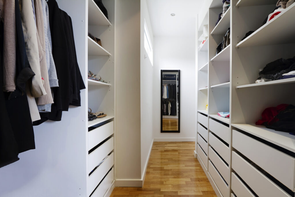 picture of a narrow walk-in wardrobe corridor