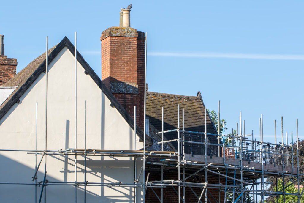 Picture of a home with scaffolding covering it