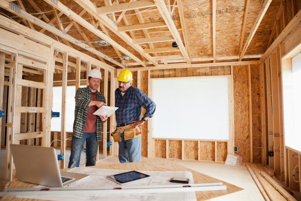 construction workers reading blueprints on a construction site