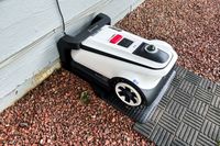 The Ecovacs Goat A3000 LiDAR Robot Lawn Mower charges in a charging station