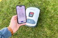 A person controls the ANTHBOT Genie 3000 Smart AI Robot Lawn Mower with their phone
