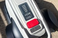 A close-up of the buttons on top of the Eufy Robot Lawn Mower E15