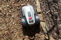 The Eufy Robot Lawn Mower E15 on dirt