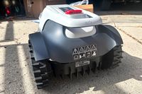 The back of the Eufy Robot Lawn Mower E15 on concrete