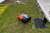 The WORX WR147 Landroid Robotic Lawn Mower cuts a small patch of grass