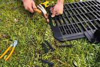 A person assembles the WORX WR147 Landroid Robotic Lawn Mower