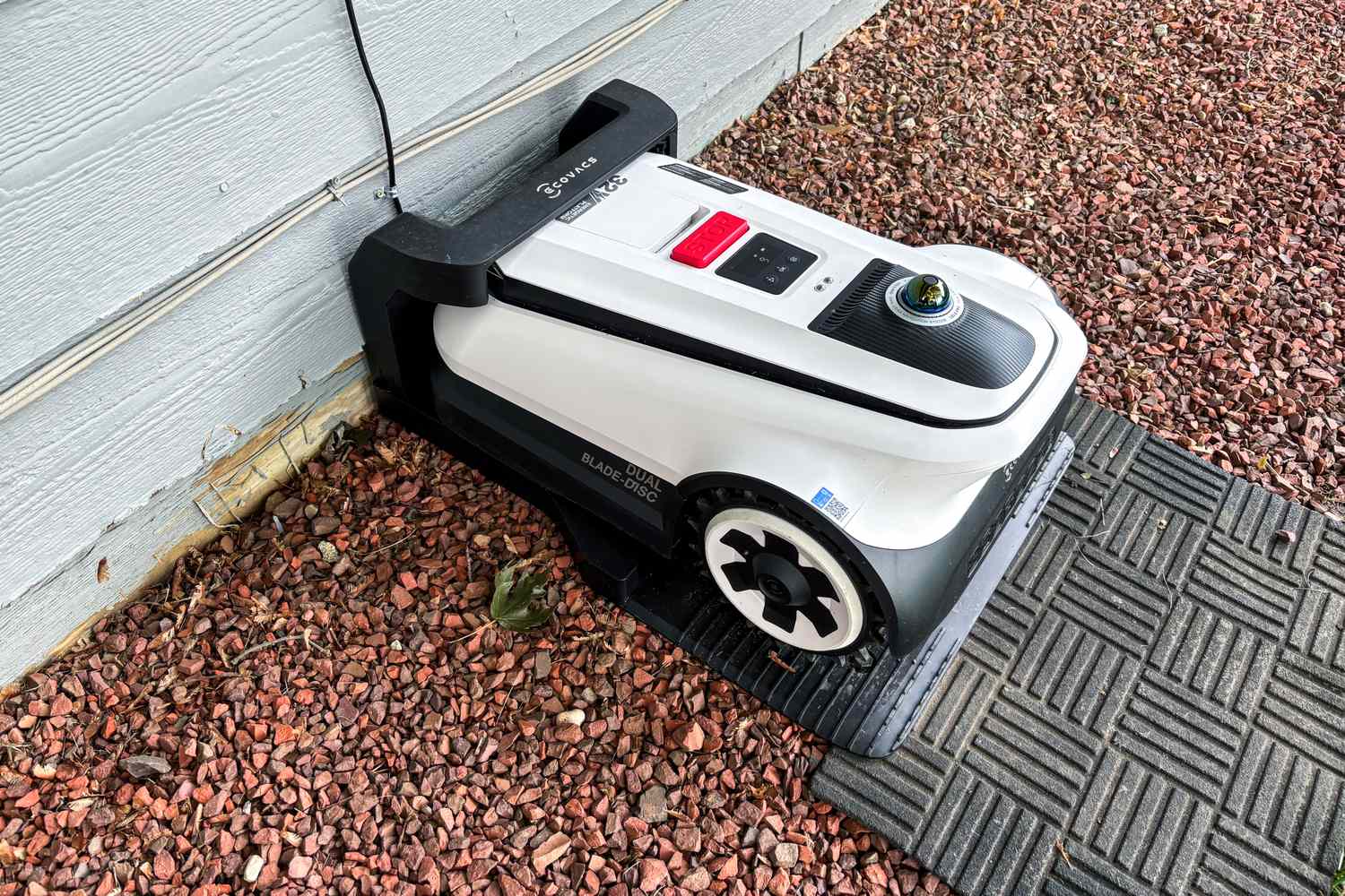 The Ecovacs Goat A3000 LiDAR Robot Lawn Mower charges in a charging station
