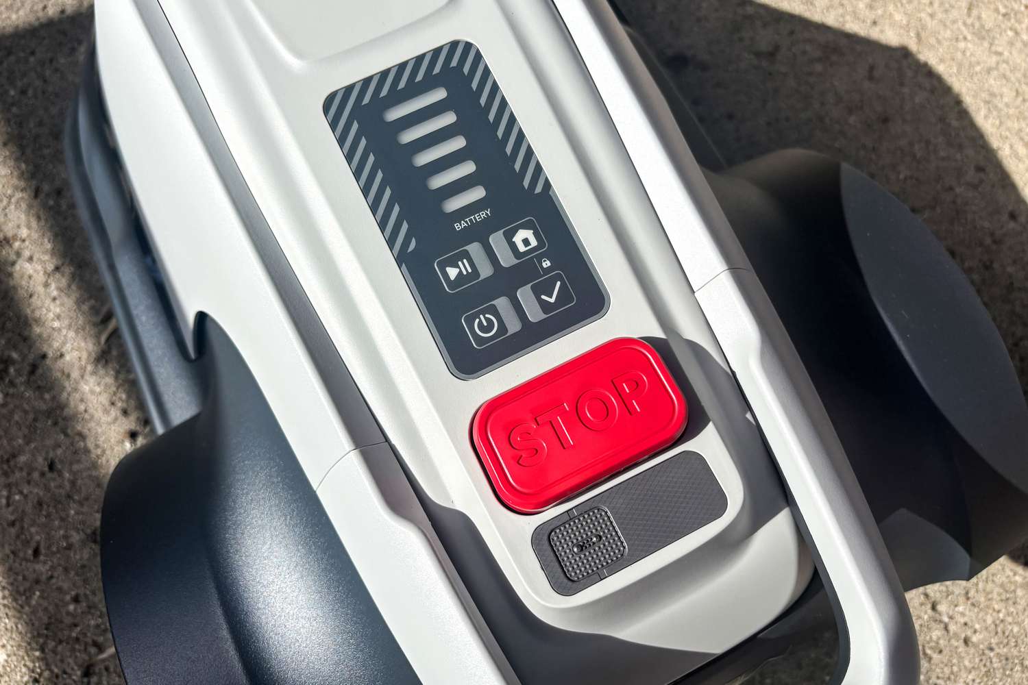 A close-up of the buttons on top of the Eufy Robot Lawn Mower E15