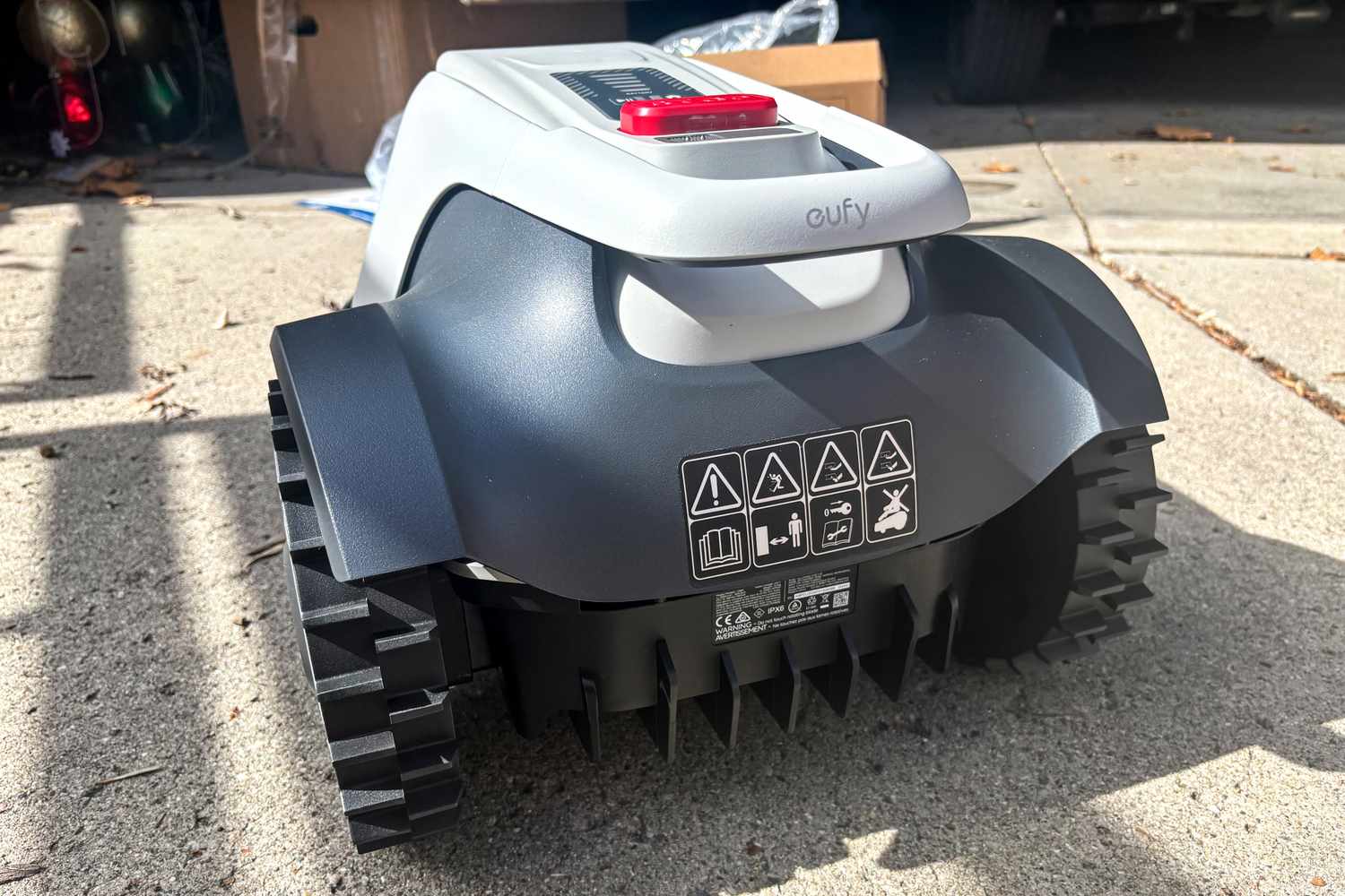 The back of the Eufy Robot Lawn Mower E15 on concrete