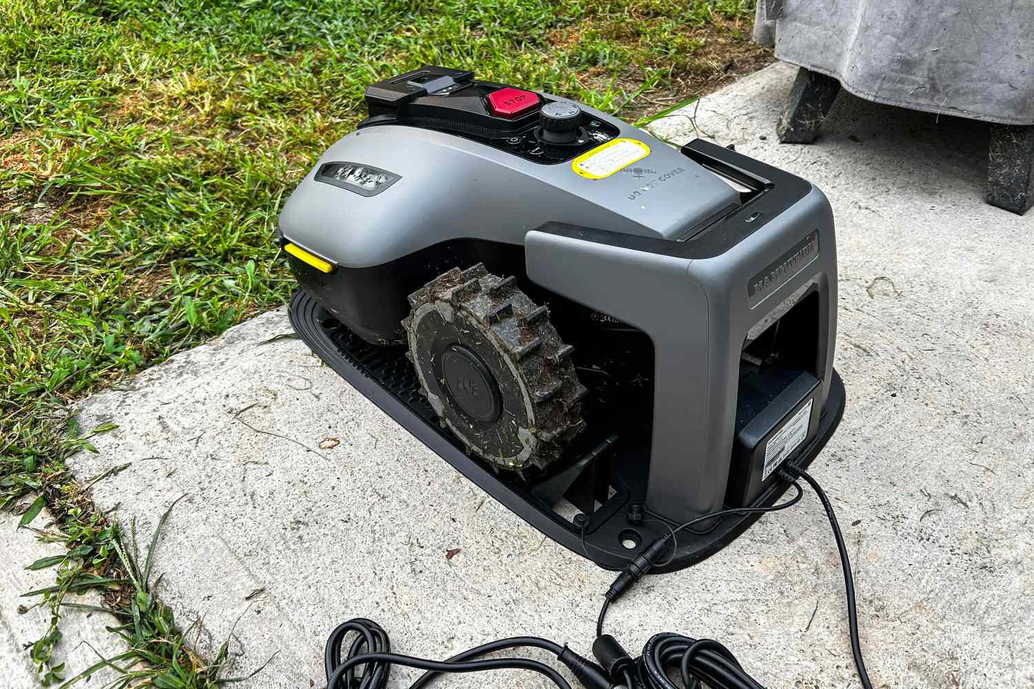 The MAMMOTION YUKA mini (H Version) Perimeter Wire-Free Robot Lawn Mower charges in a charging station