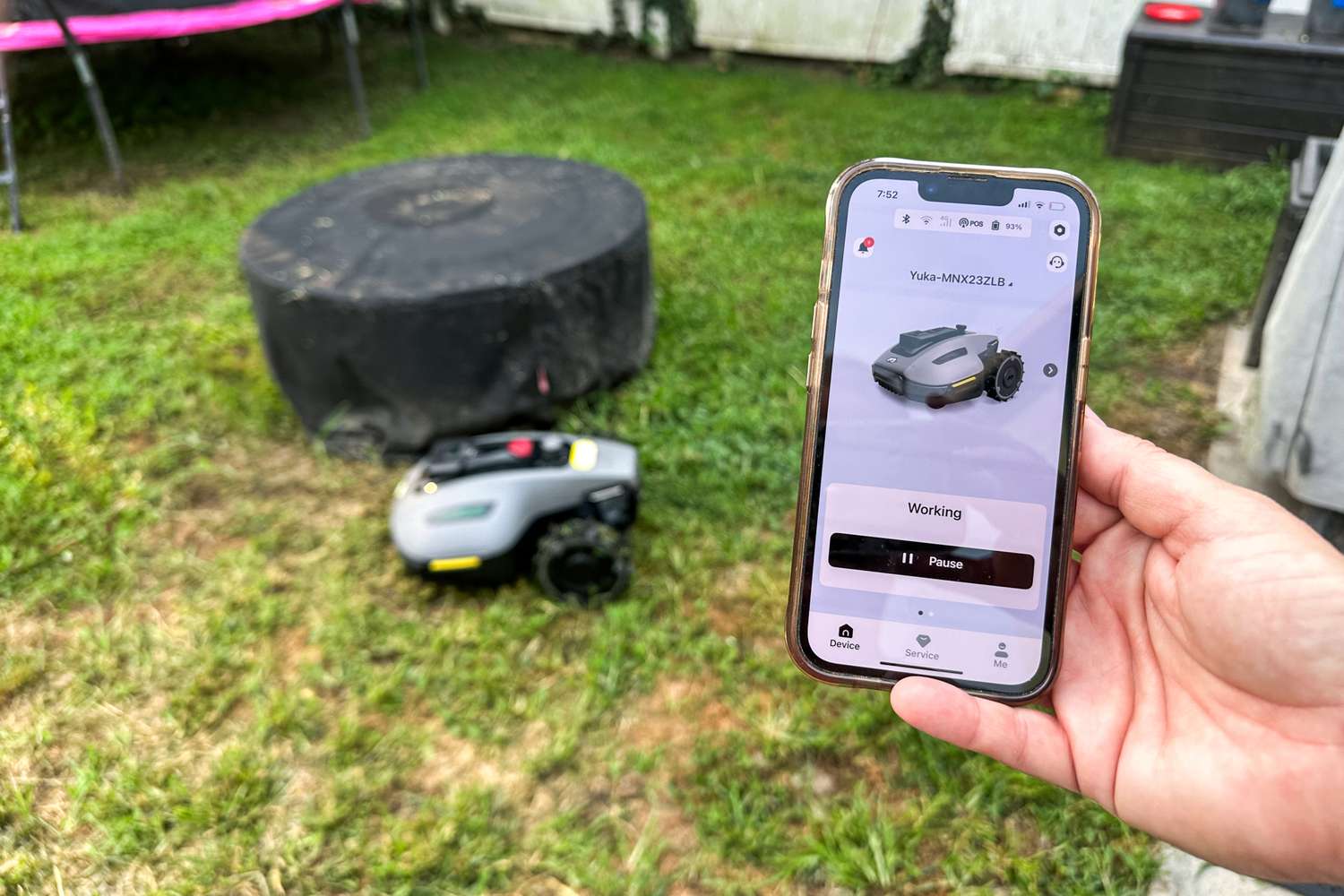 A person controls the MAMMOTION YUKA mini (H Version) Perimeter Wire-Free Robot Lawn Mower with a smartphone