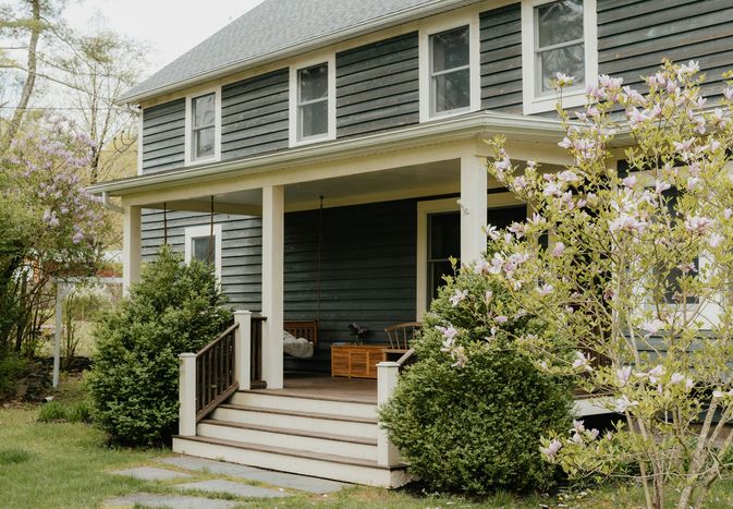 Older home exterior with wood siding and porch